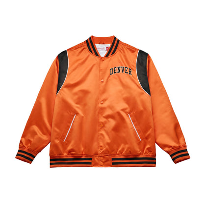 An orange satin varsity-style jacket with black ribbed trim, black shoulder panels, and 'DENVER' embroidered in navy on the chest, shown on a plain white background.