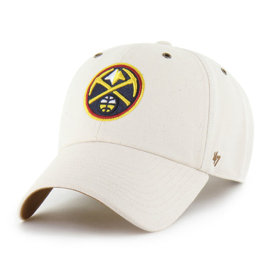 Front left view of a structured hat with an off-white crown and brim, and a circular primary Nuggets logo on the front featuring crossed gold picks and a mountain, with a small '47' brand mark on the left side.